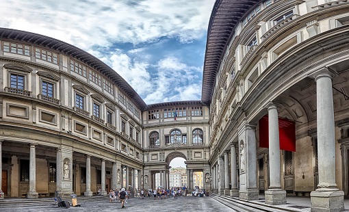 Uffizi Gallery in Florence under a blue sky with clouds, panorama