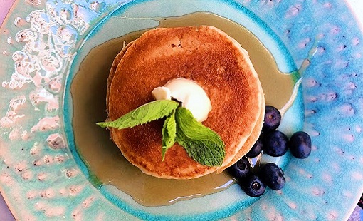 Blueberry pancakes at cafe for young travelers